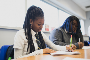 Students writing at desks